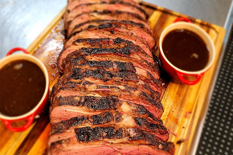 Sliced smoked brisket with BBQ sauce